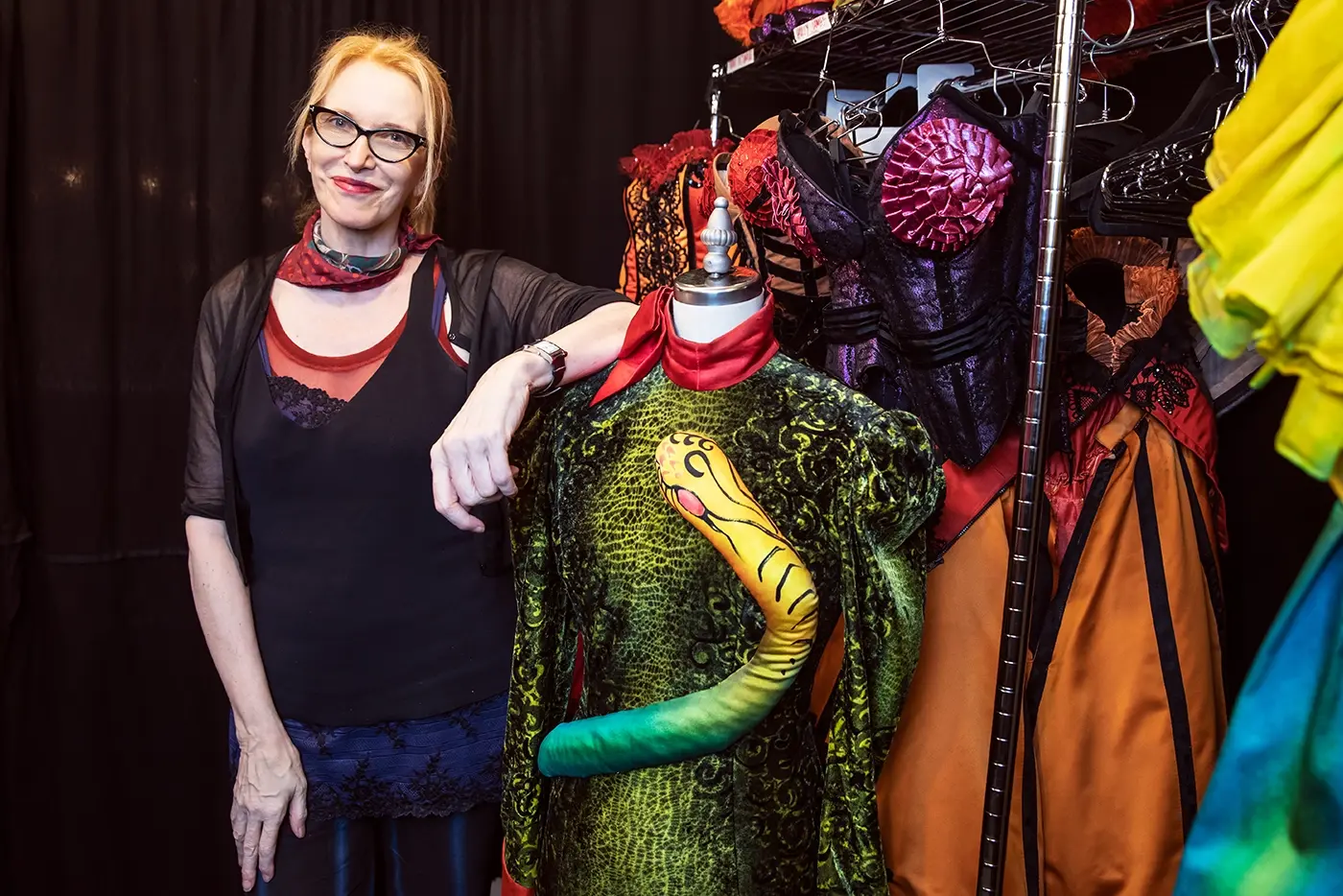 Catherine Zuber, costume designer of Moulin Rouge! The Musical, posing with some of the production's costumes.