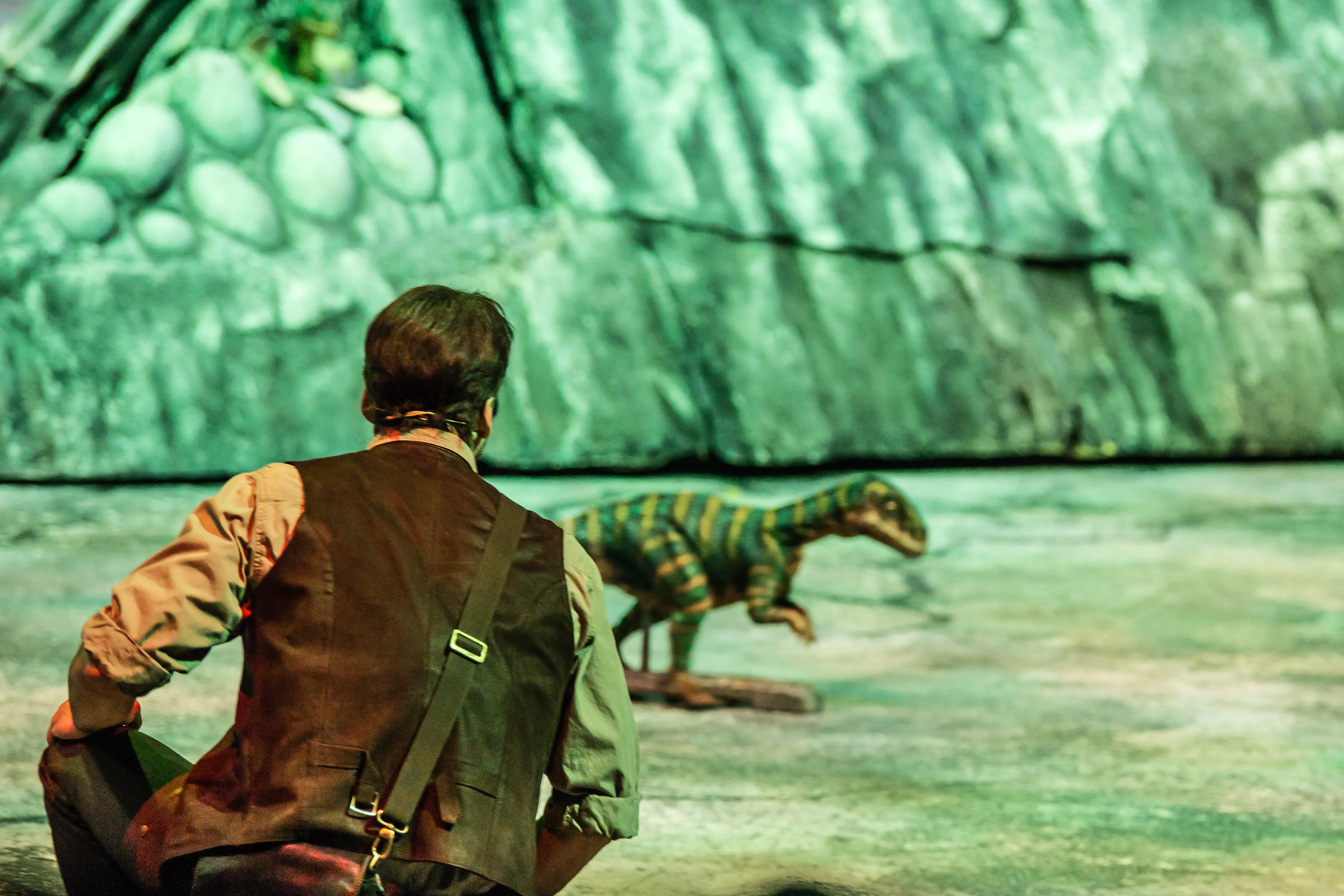 Huxley sneaking up on baby dinosaur in Walking with Dinosaurs live arena show