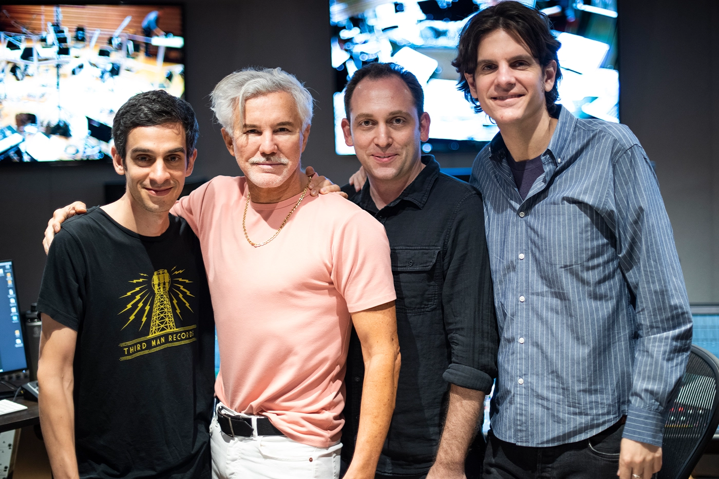 Justin Levine, Baz Luhrmann, Matt Stine, and Alex Timbers standing together and smiling into the camera.