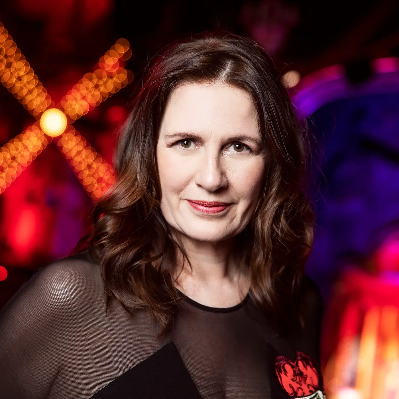 Carmen Pavlovic - Founder, CEO and Producer at Global Creatures standing in front of the set of Moulin Rouge! The Musical