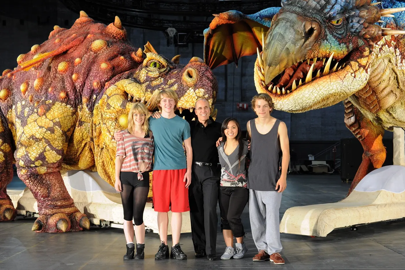 Cast in front of dragon puppets