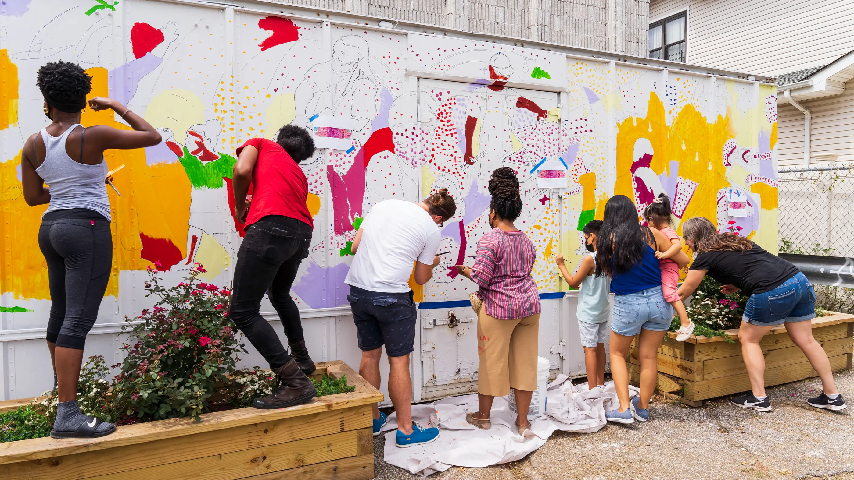 Cast and crew painting a mural for Groundswell Art