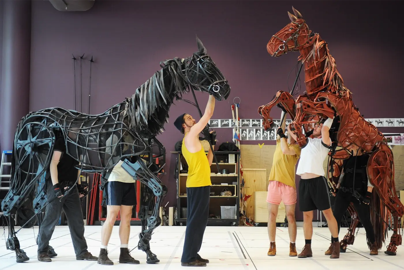 actors working with life sized horse puppets in the rehearsal room.