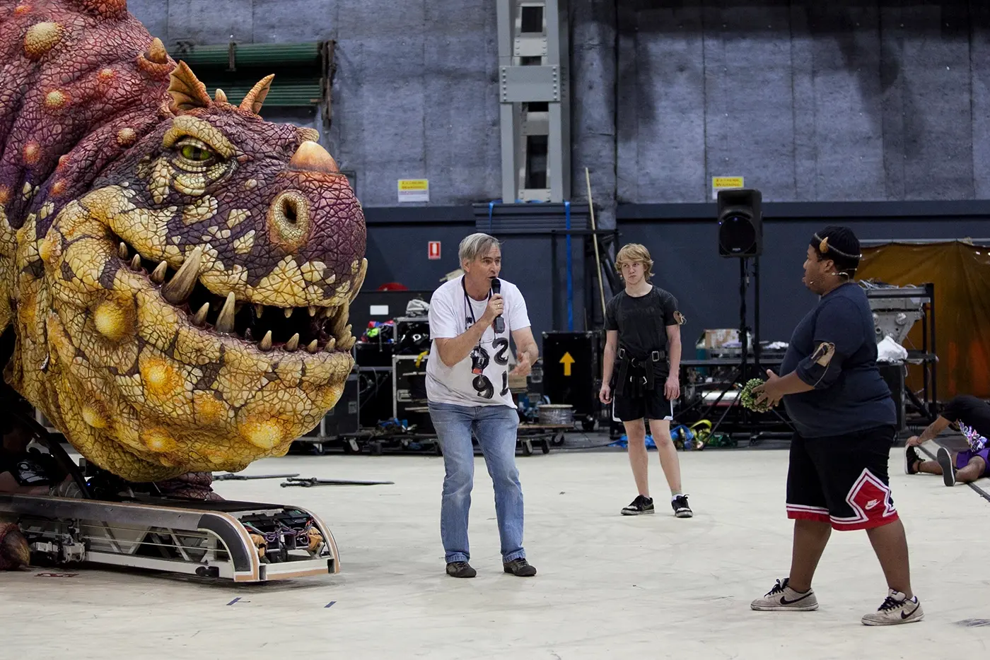 Director Nigel Jamieson giving direction to cast infront of a dragon puppet