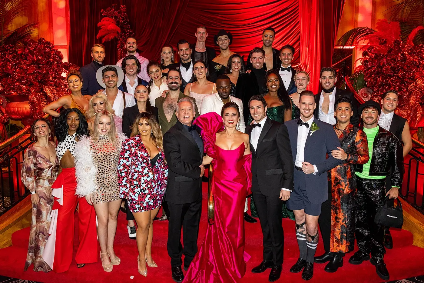 The cast of Moulin Rouge! The Musical are grouped together in formal attire, smiling for the camera at the Opening Night afterparty for Moulin Rouge! The Musical in Sydney.