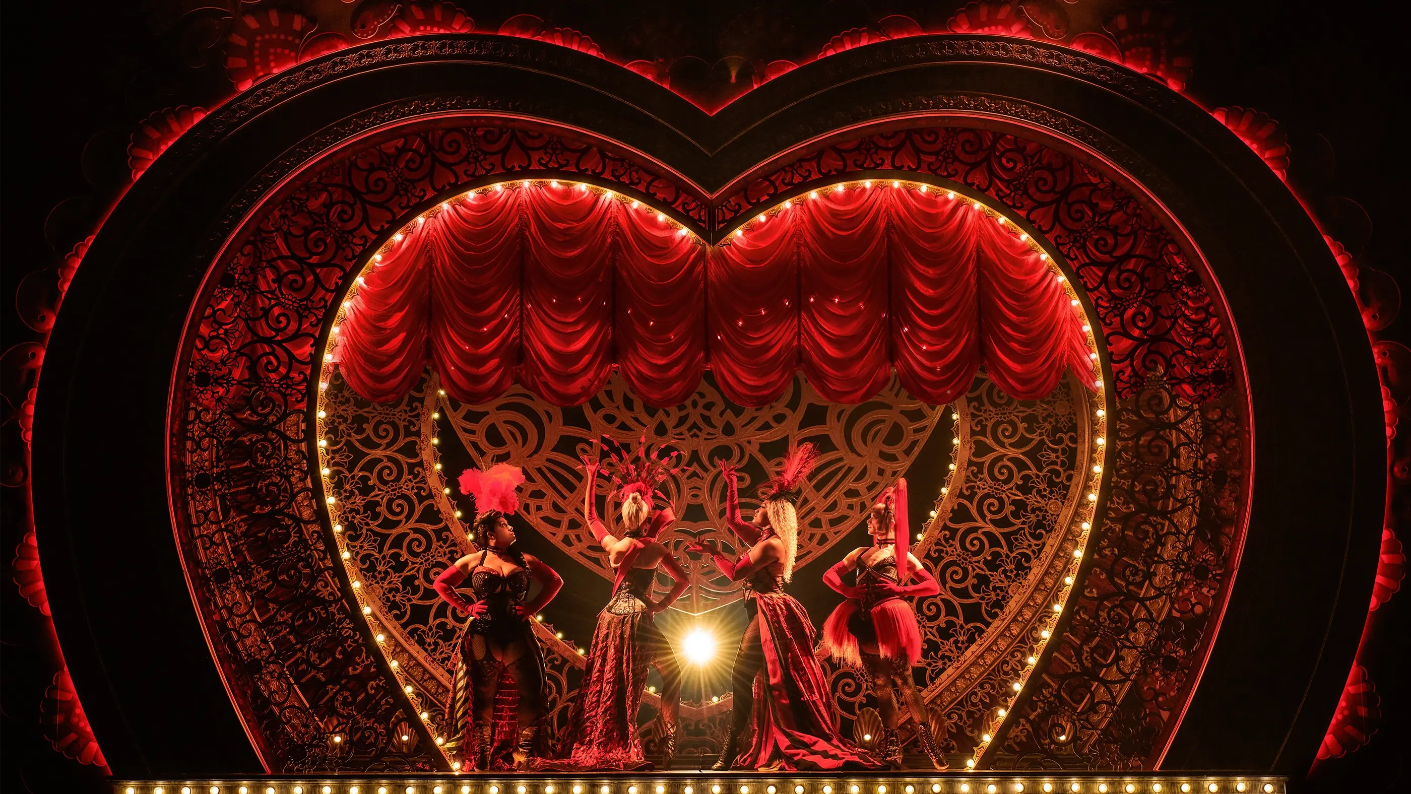The four Lady Ms posing on stage during the opening scene of Moulin Rouge! The Musical