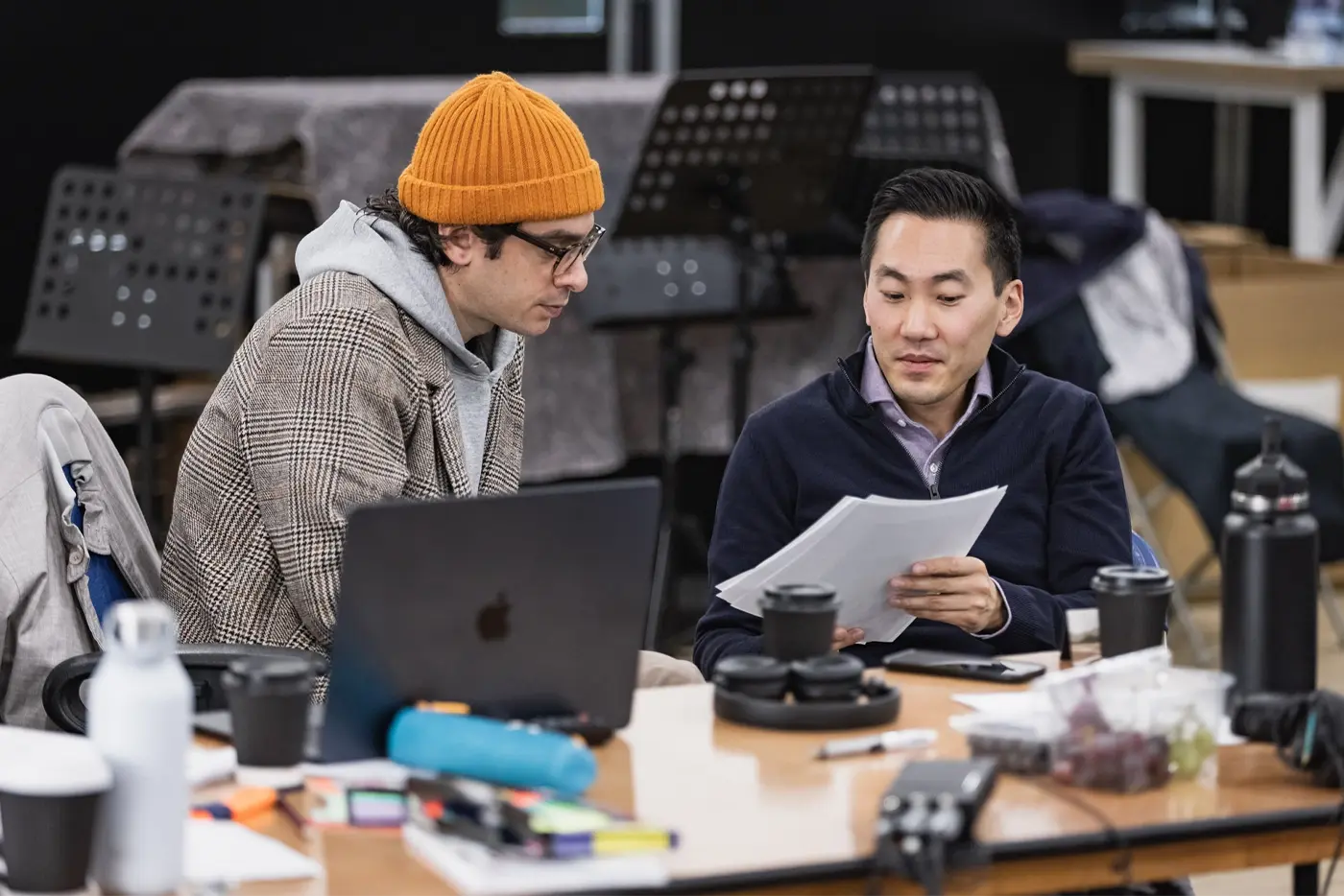 Justin Levine and Music Supervisor Ted Arthur looking at a paper together during rehearsals of the Moulin Rouge! The Musical World Tour.