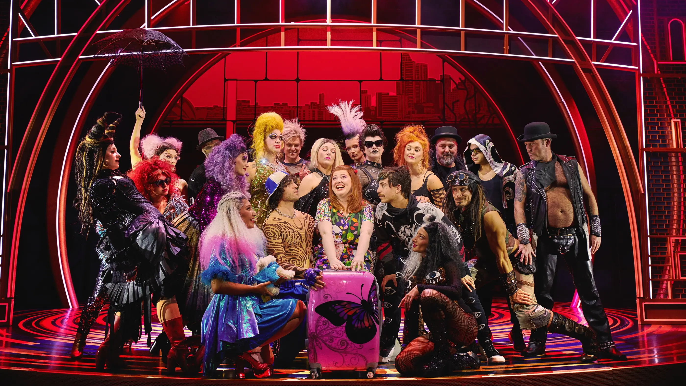 Muriel with her packed suitcase surrounded by people