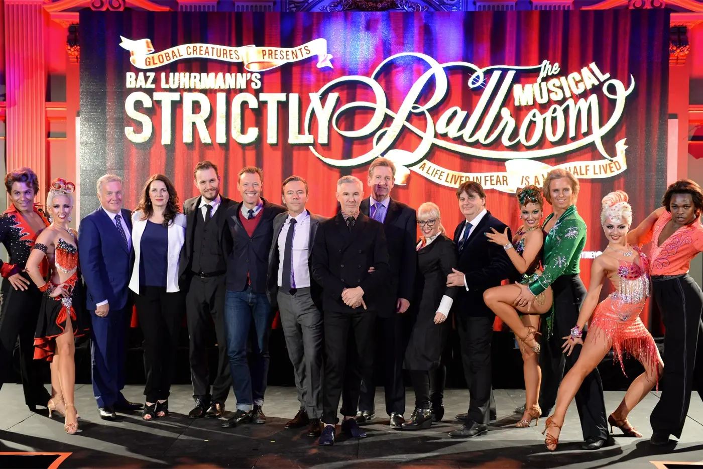 Strictly Ballroom The Musicals creatives onstage in front of a poster with cast in character at a media call