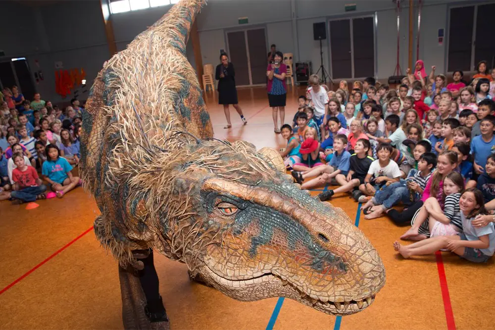 Dinosaur puppet from Walking with Dinosaurs - Arena Spectacular with school students