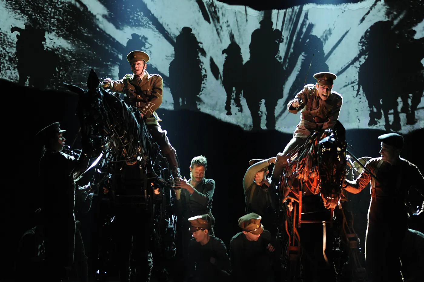 War Horse theatre production: horse puppets and performers in a key scene.