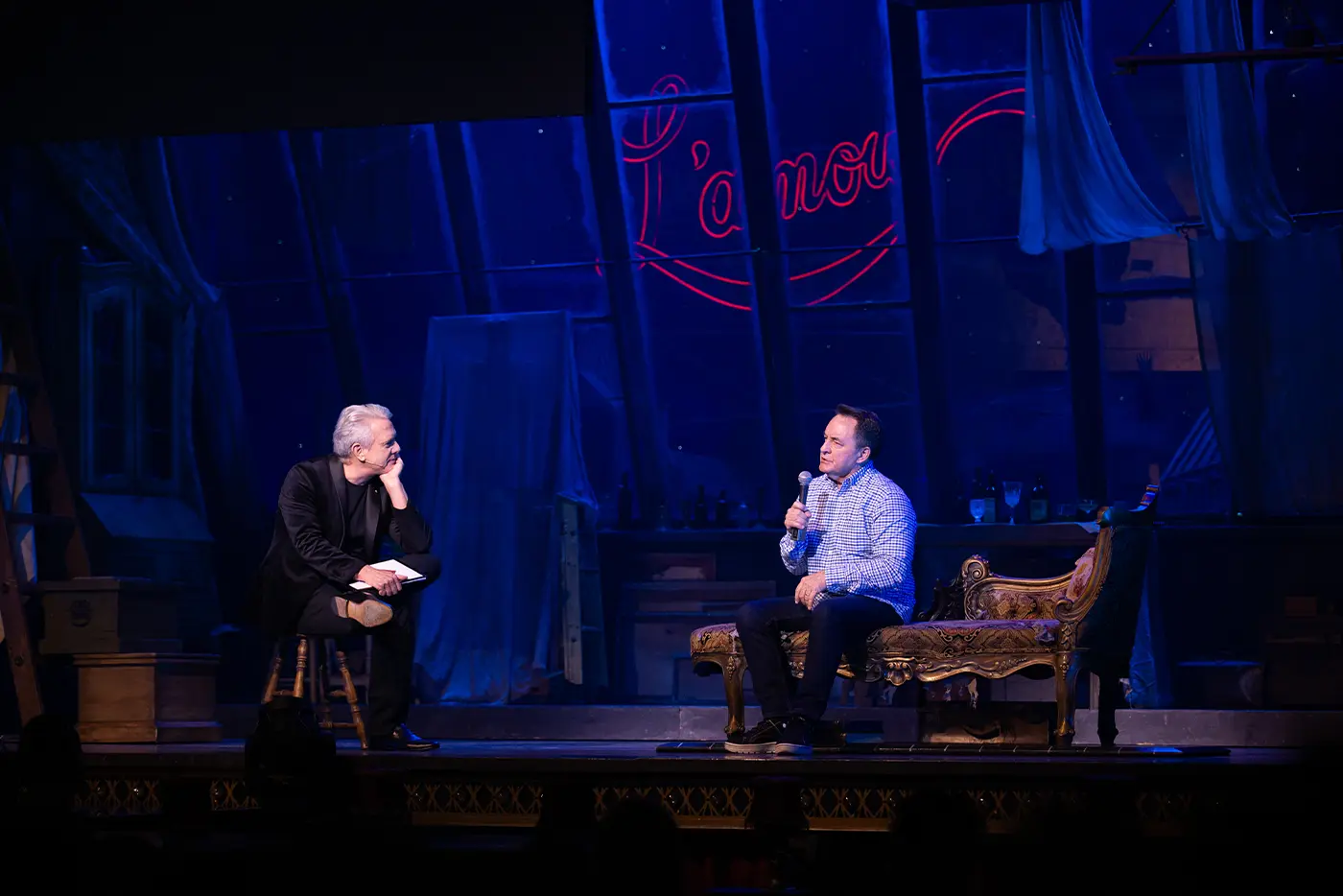 Simon Burke interviewing Richard Martin, Technical Director, on stage during 'Get Technical! Behind The Curtain of Moulin Rouge! The Musical'