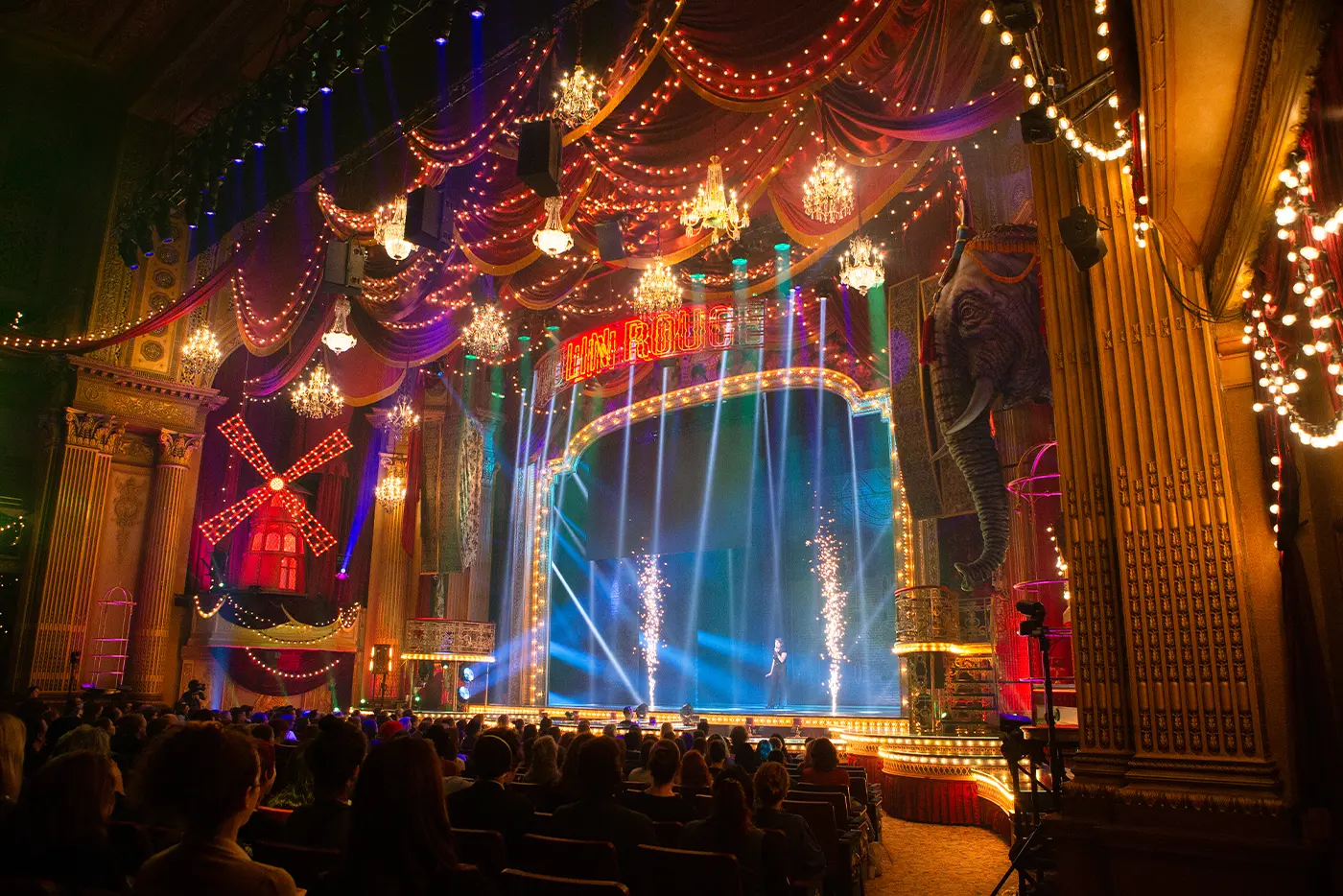 A lighting department crew member showing off the lighting effects used in Moulin Rouge! The Musical on stage during 'Get Technical! Behind The Curtain of Moulin Rouge! The Musical'